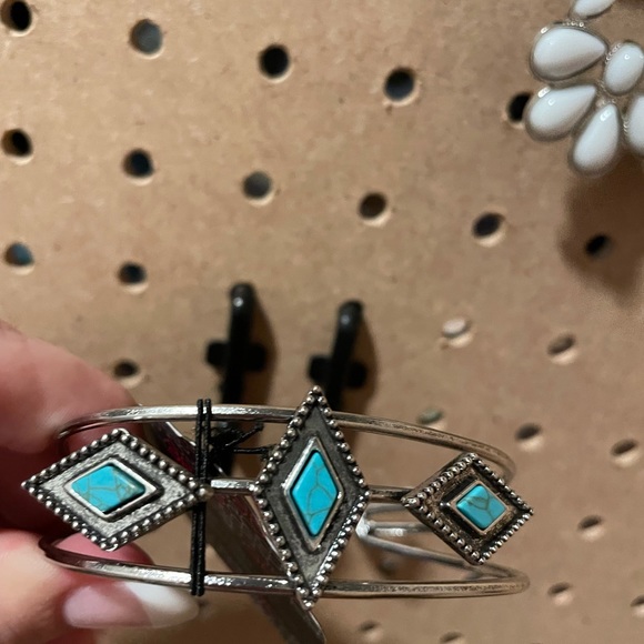 Openwork silver cuff with turquoise diamond accents.
